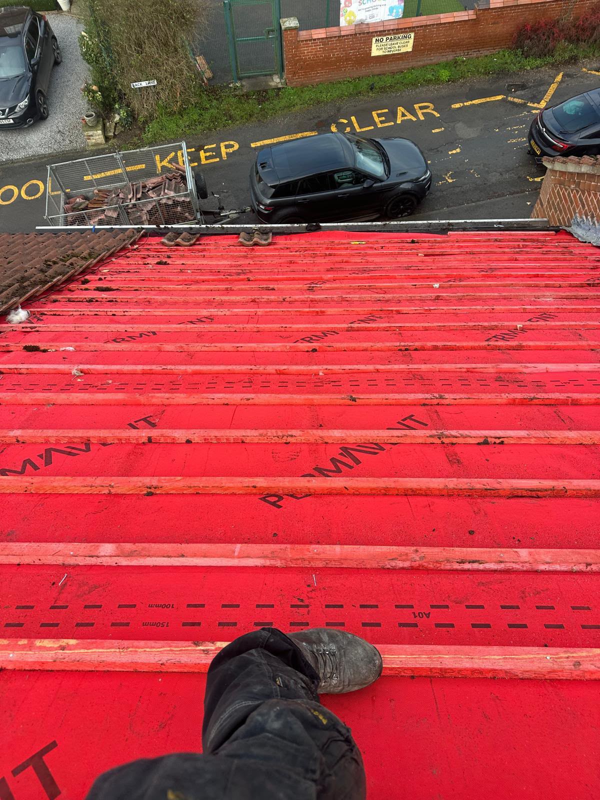 Bright red Permavent breathable membrane and timber battens on a new roof build-up