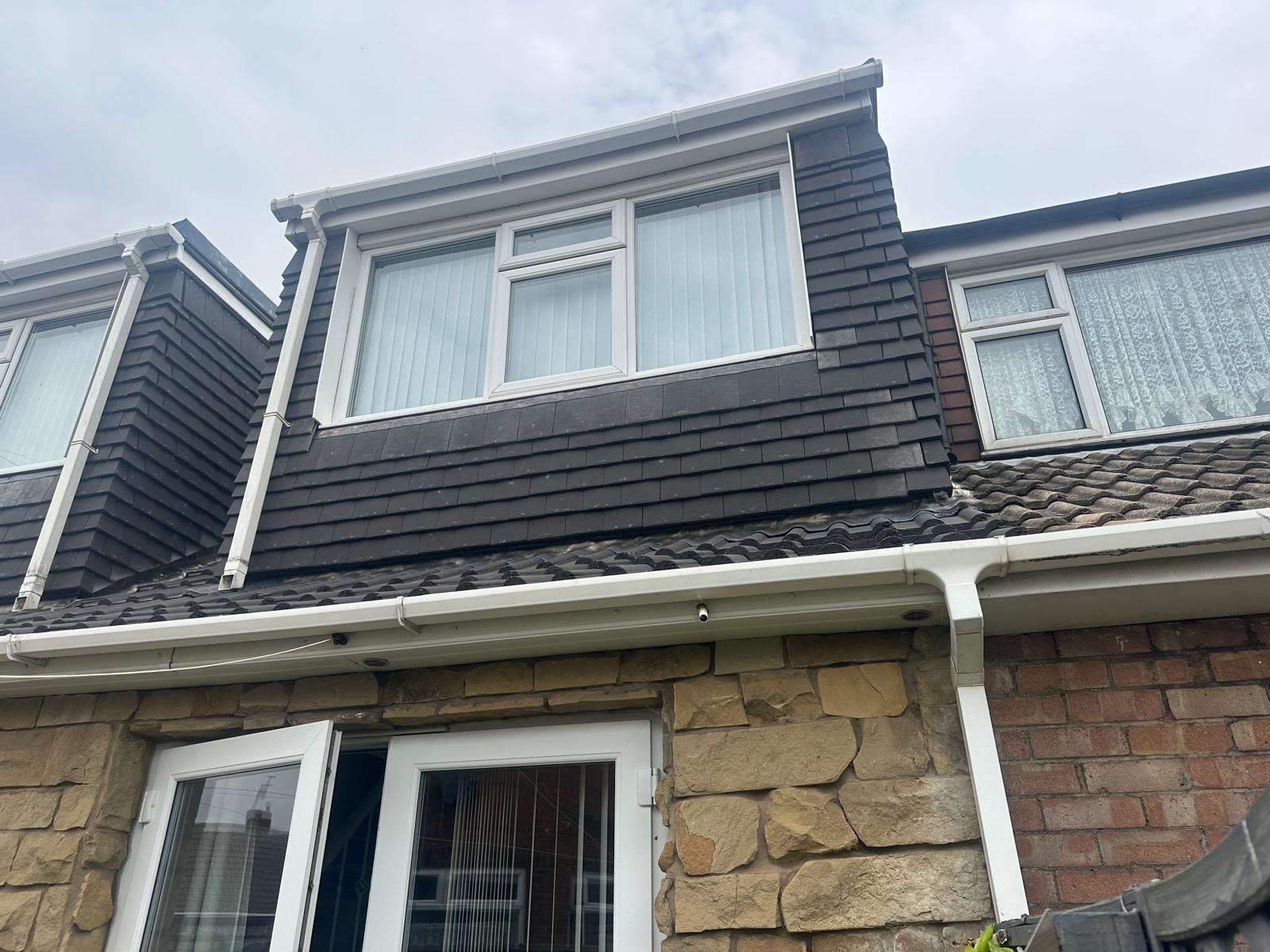 New white UPVC fascias, soffits, guttering and downpipe fitted to a tiled dormer in Yorkshire