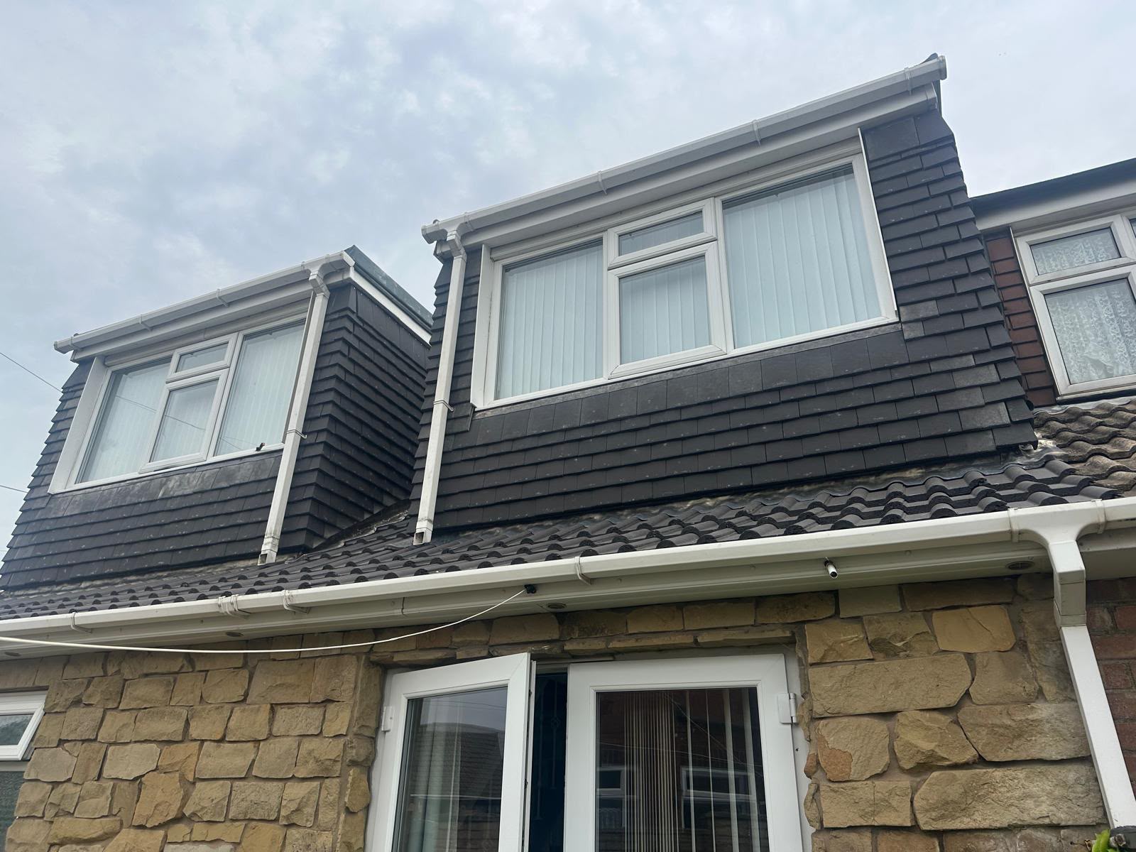 New dormer roof with dark grey tiles and white UPVC fascias, soffits and guttering fitted by One Stop Roofing in Yorkshire