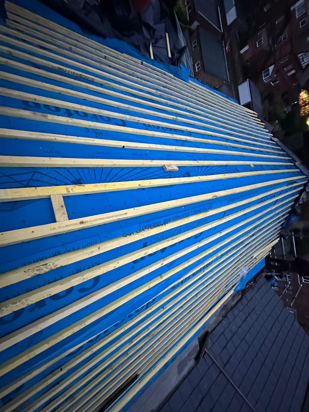 Blue breathable roofing membrane and timber battens installed across a large pitched roof