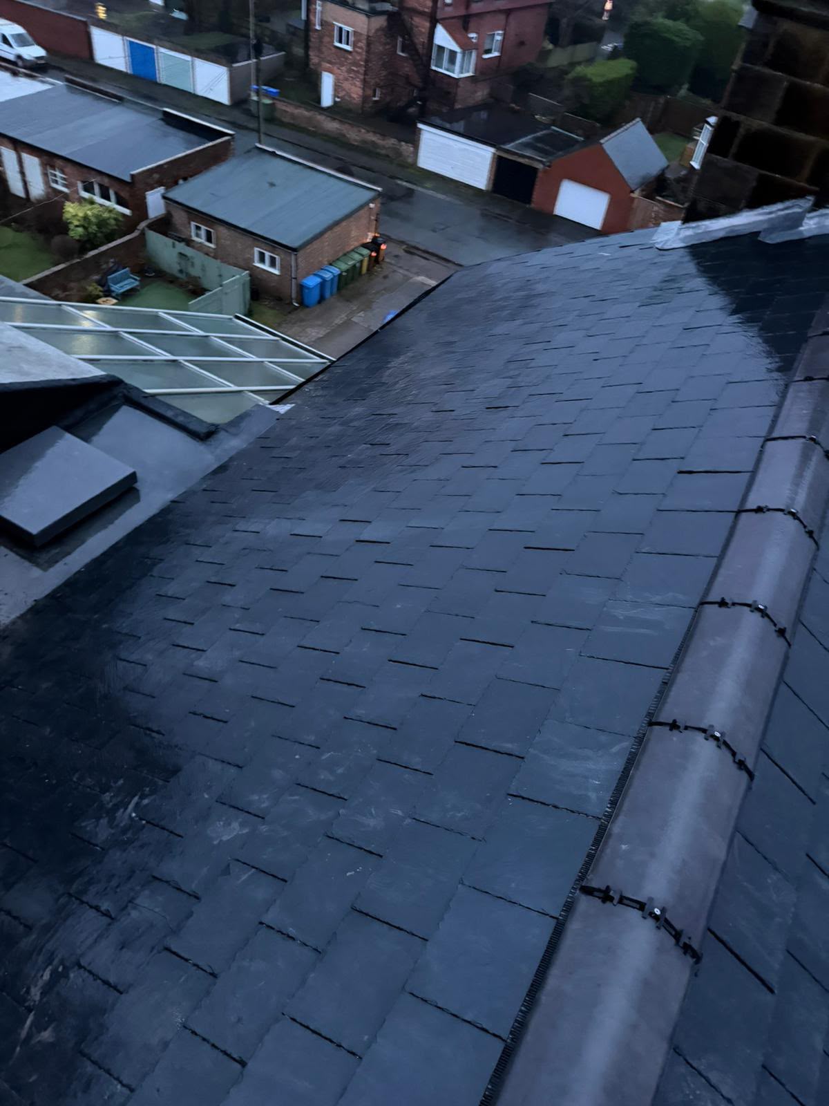 New grey slate roof with dry ridge system photographed at dusk in Yorkshire