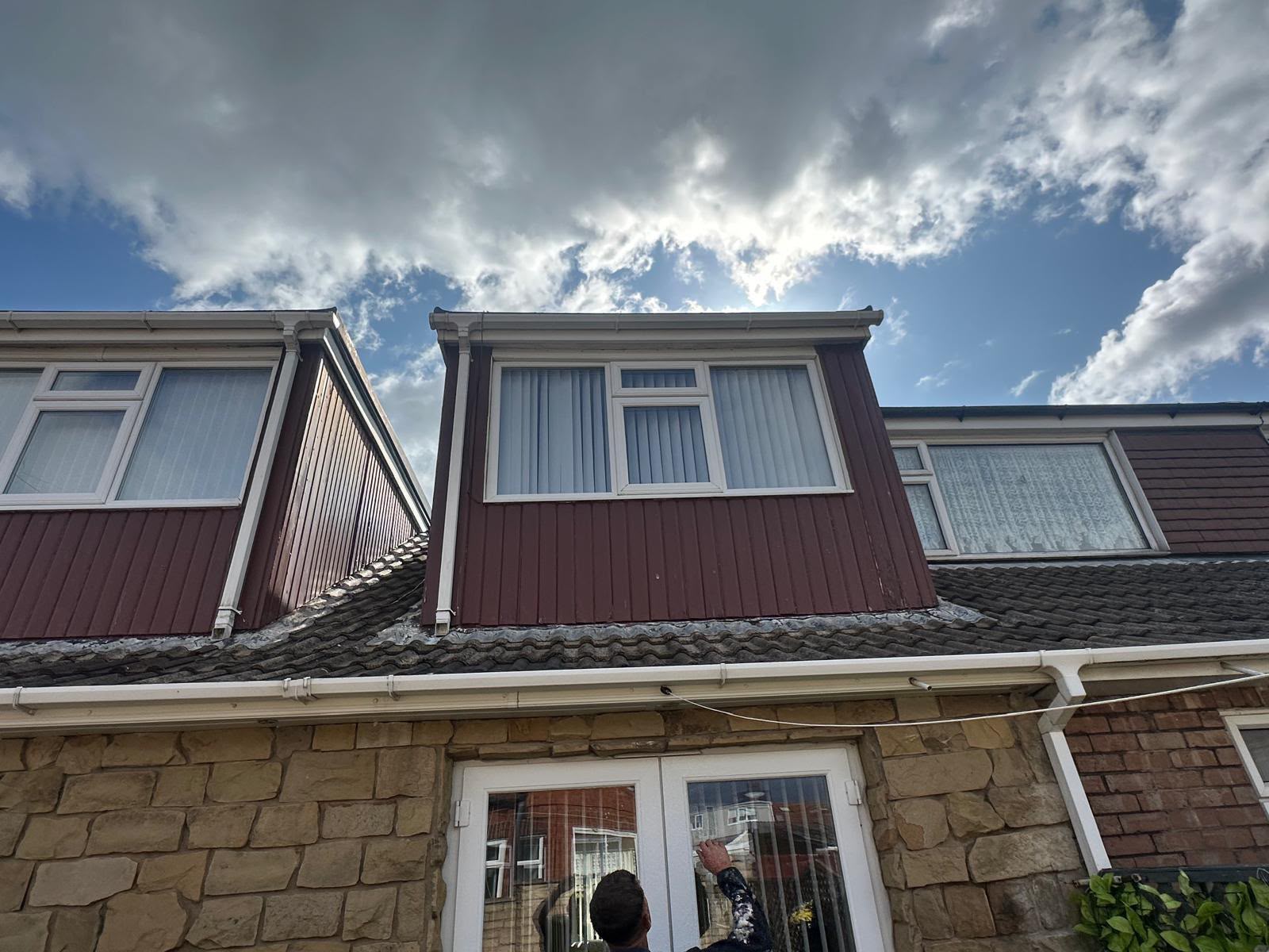 Brown dormer cladding with newly fitted white UPVC guttering