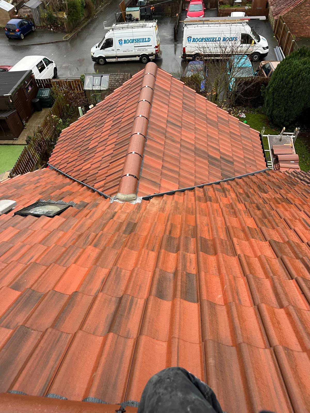 Completed red tiled hipped roof on a Yorkshire property, viewed from the ridge