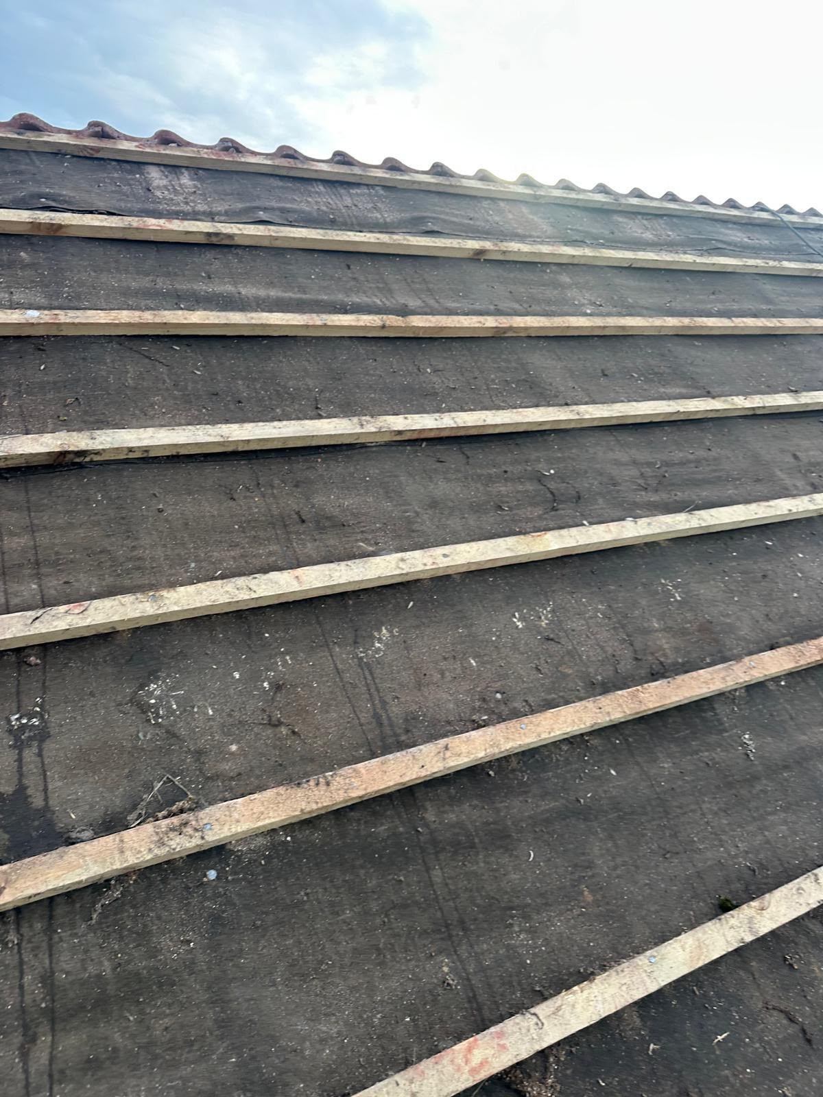 Old felt underlay exposed with new battens being fitted during a re-roof