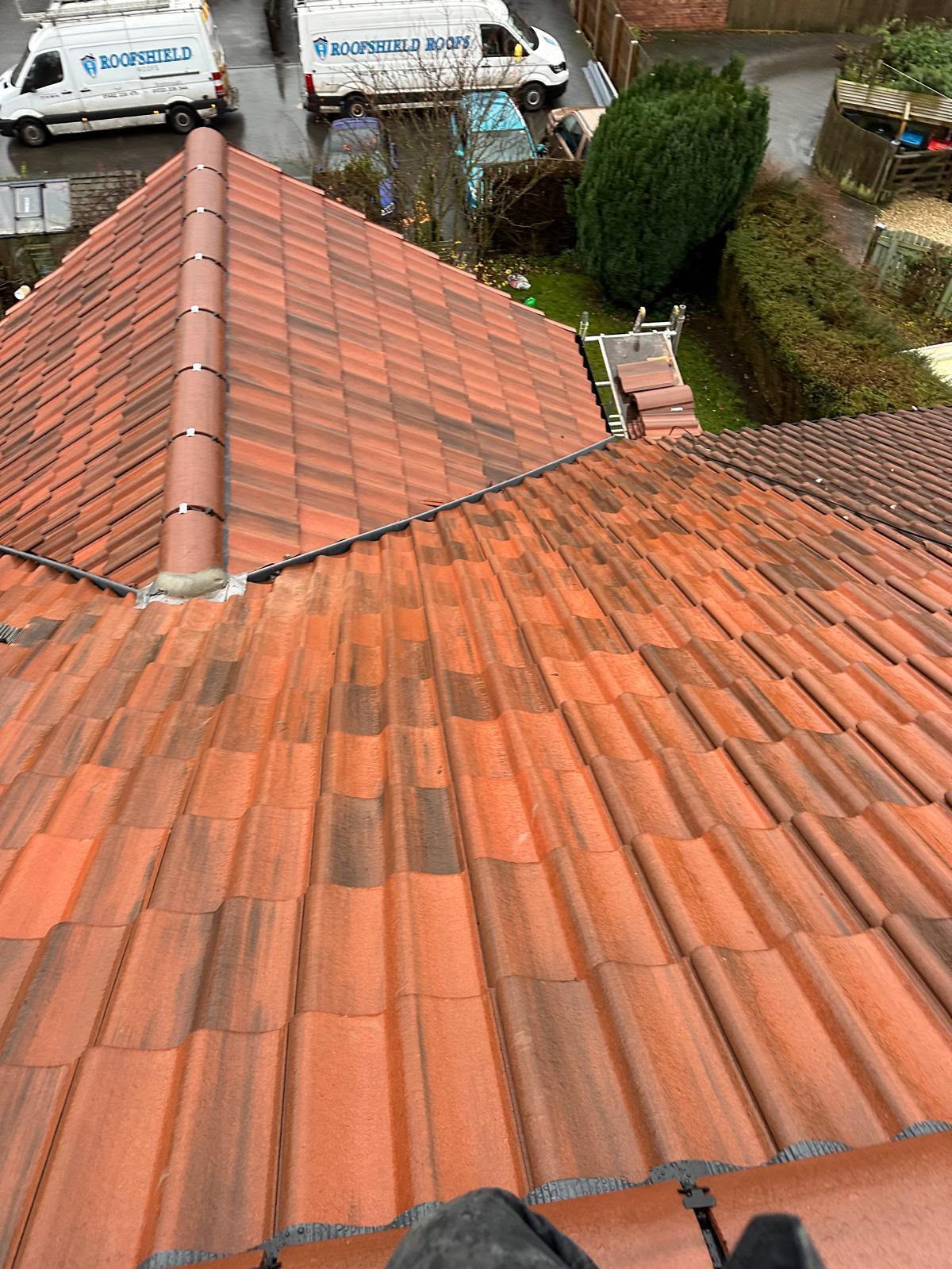 New red tiled hipped roof with a mechanically-fixed dry ridge and dry hip system