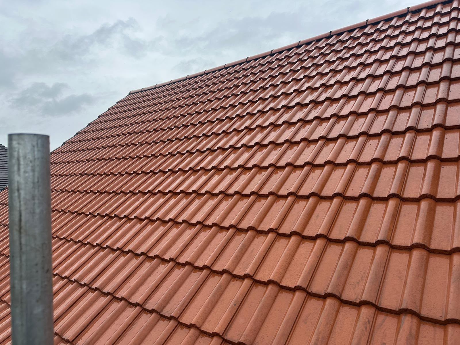 Close-up of uniform red interlocking tiles on a newly completed roof