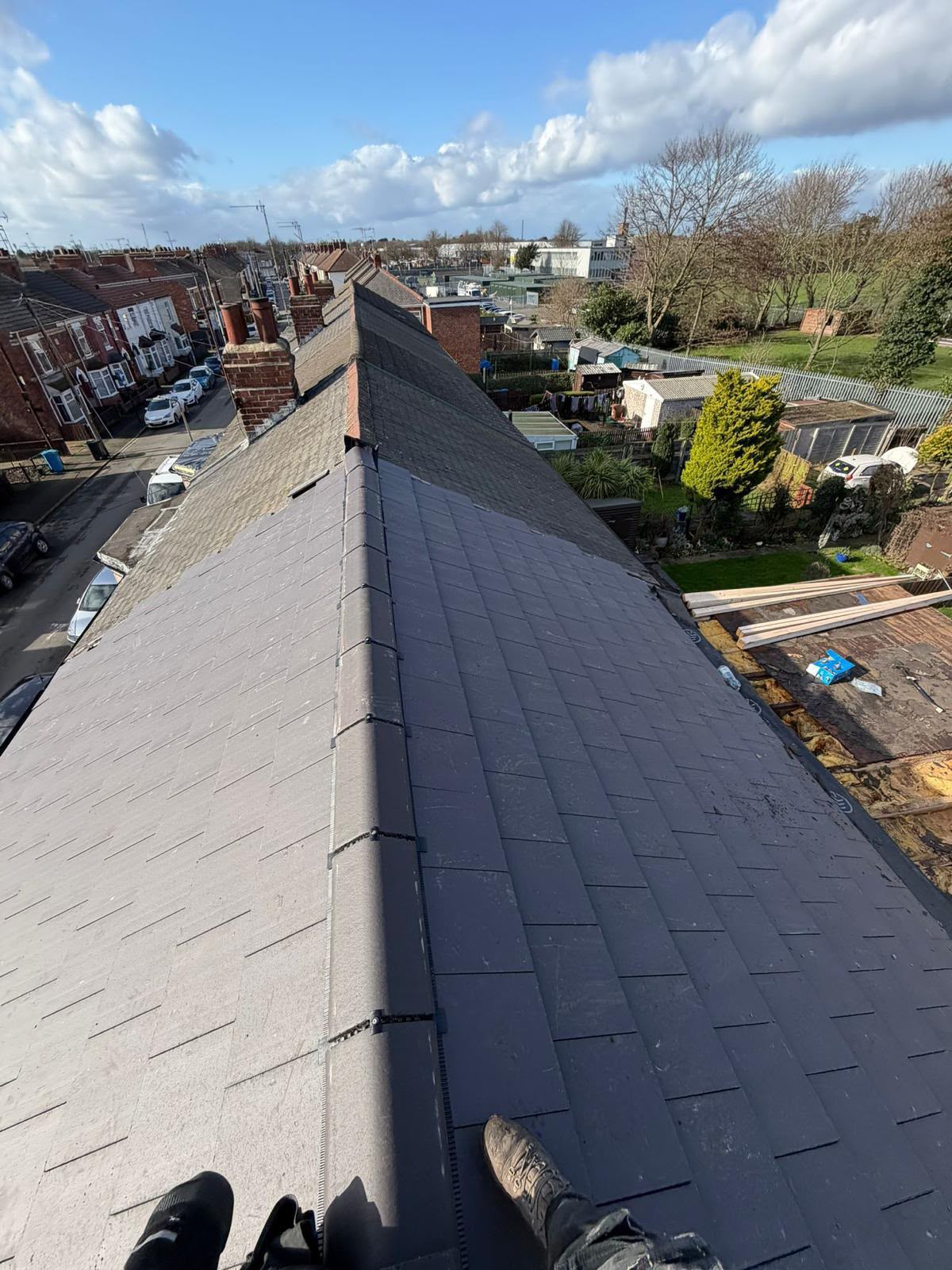 New grey slate-style roof with matching ridge and hip tiles installed to Building Regs