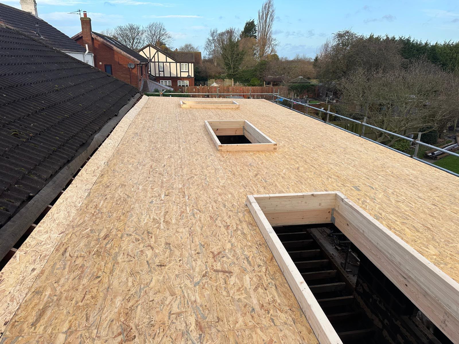 Flat roof OSB decking with timber upstands framed for two rooflights